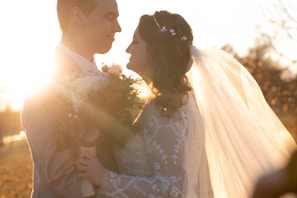 Elegant bride and groom sharing a candid laugh during a sunset wedding ceremony