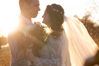 Elegant bride and groom sharing a candid laugh during a sunset wedding ceremony