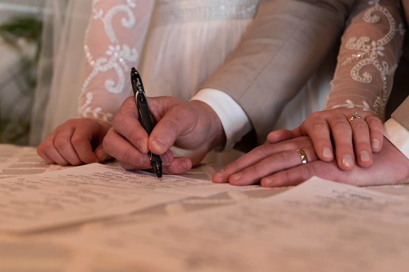 Red flags when hiring wedding planners — A couple reviews a contract with their wedding planner during an initial consultation.