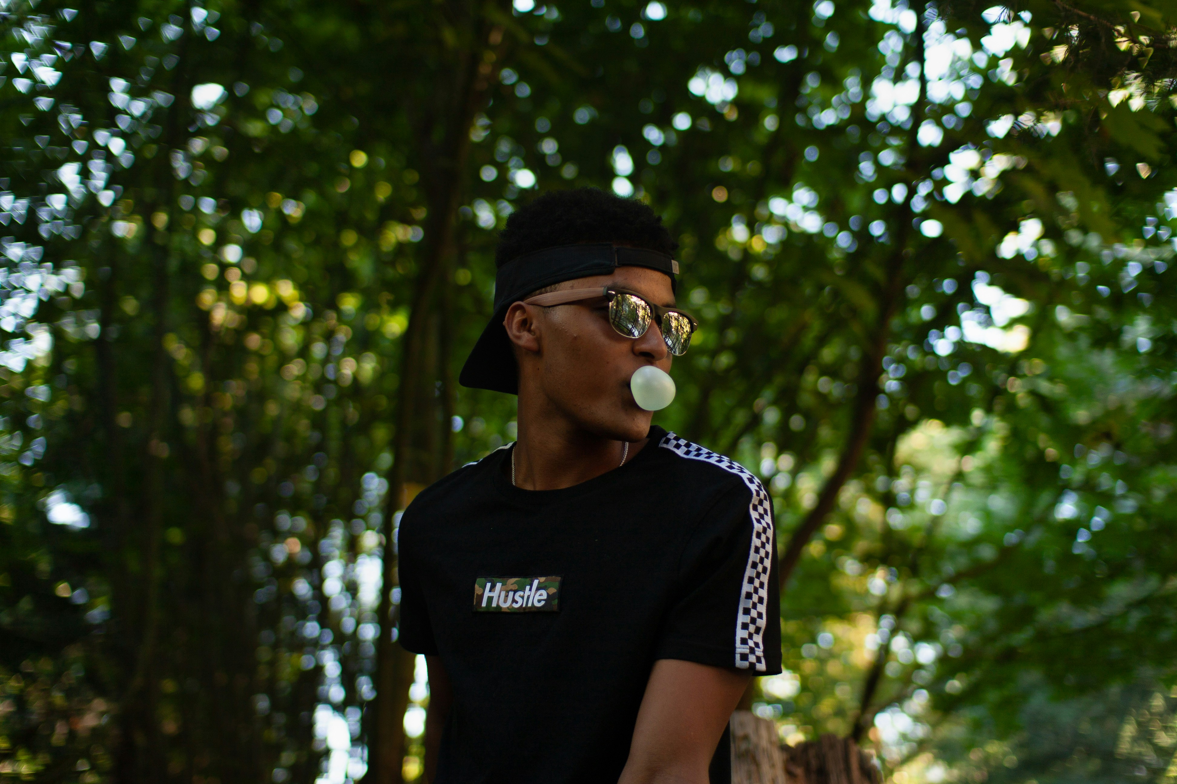 a man blowing a bubble with his mouth