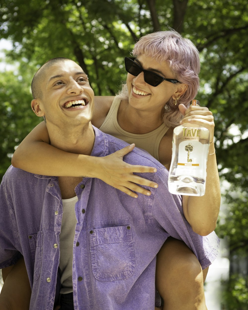 man in blue denim button up shirt holding woman in white tank top