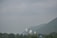 A serene landscape of an Indian temple surrounded by lush greenery.