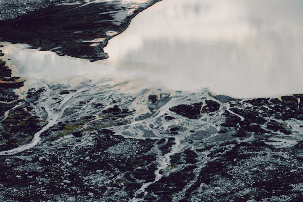 black and white rock formation near body of water