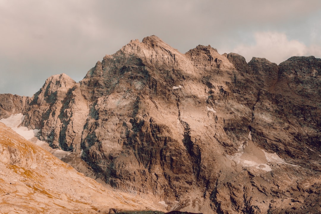 brown rocky mountain under cloudy sky during daytime