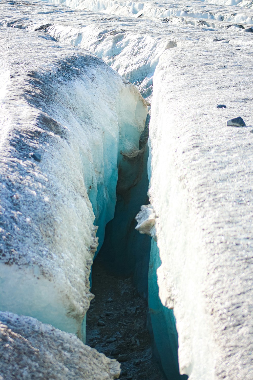 white ice on gray sand during daytime