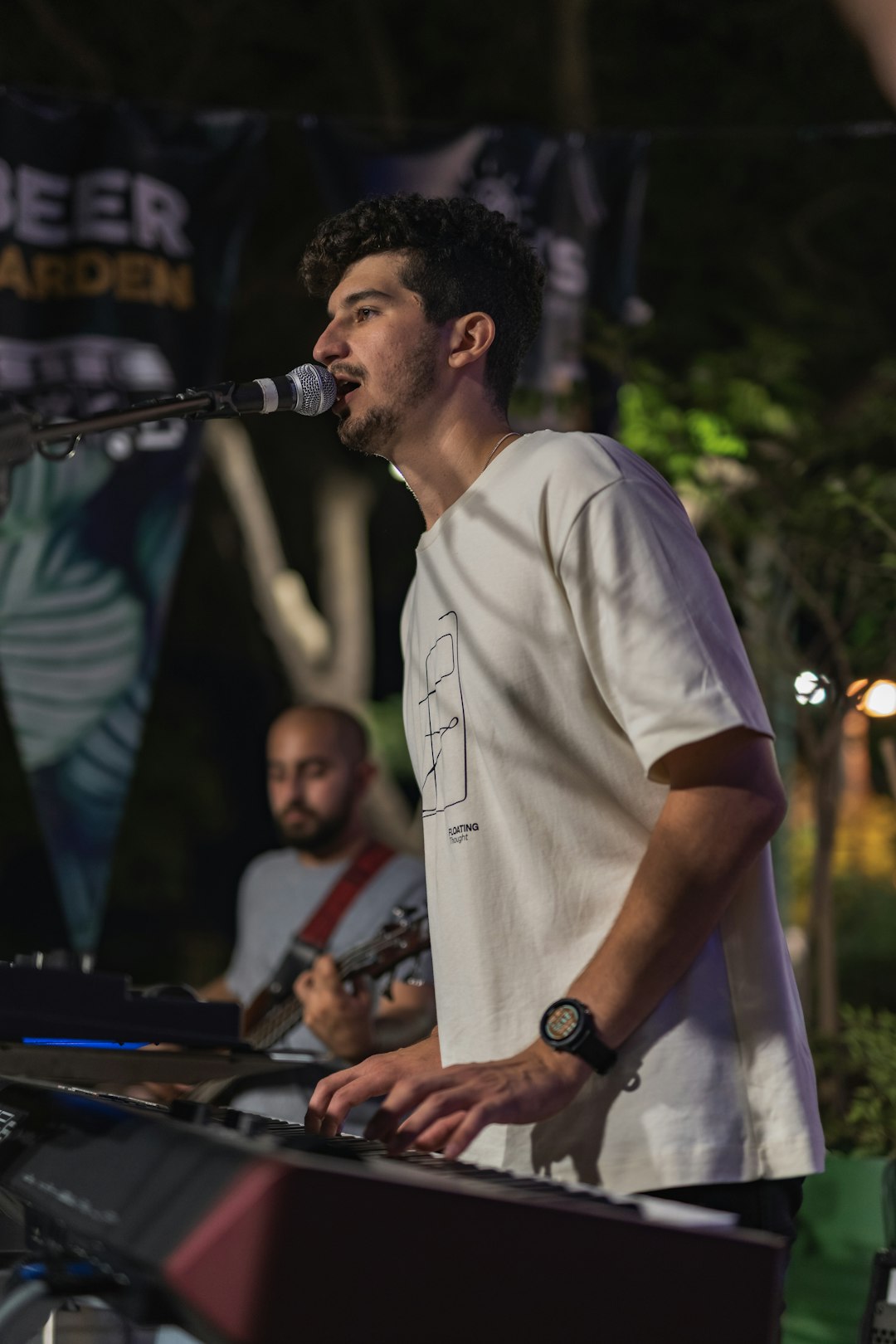 man in white crew neck t-shirt singing