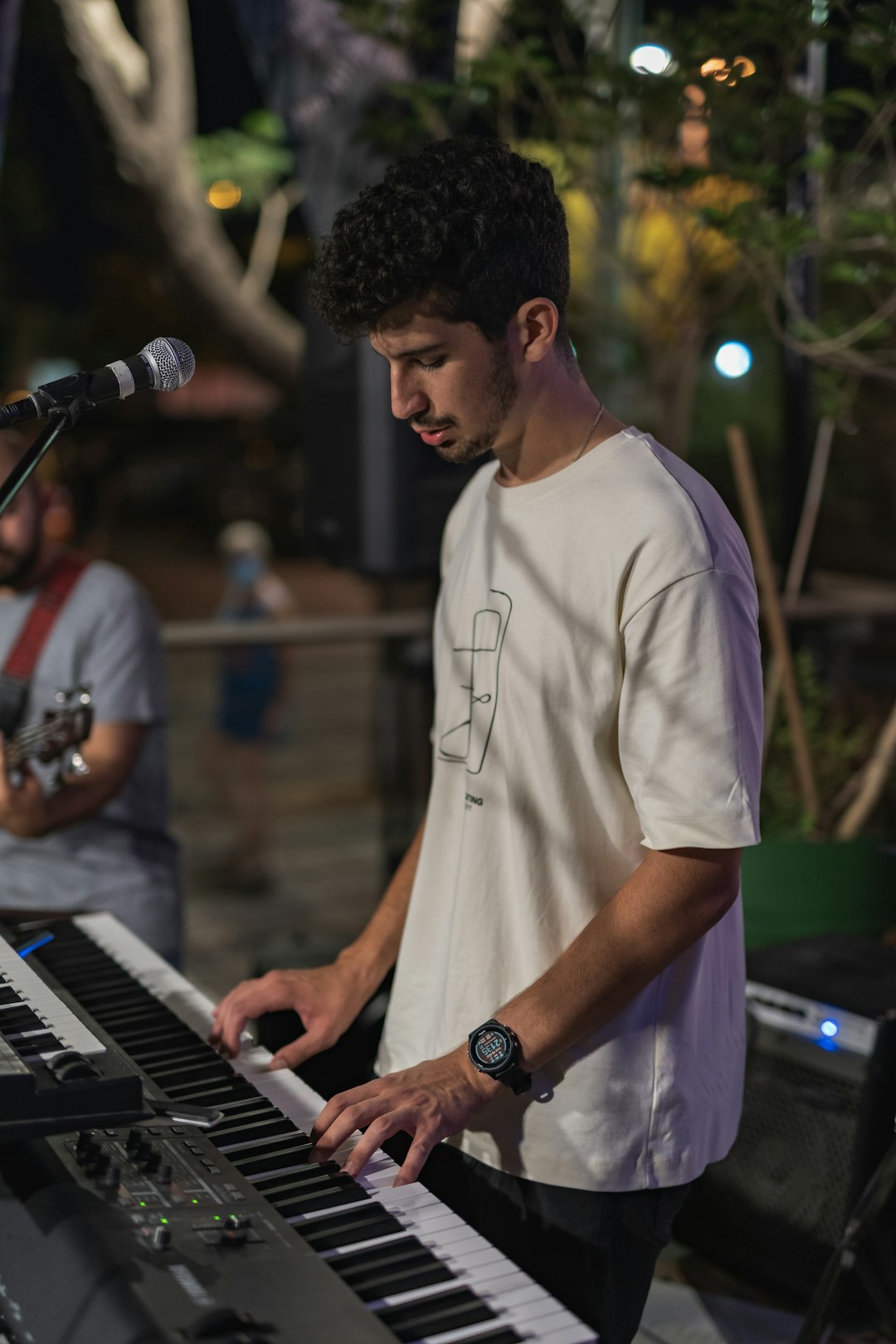 man in white crew neck t-shirt playing piano