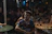 A happy young man enjoying a lively local event in a cozy urban setting.