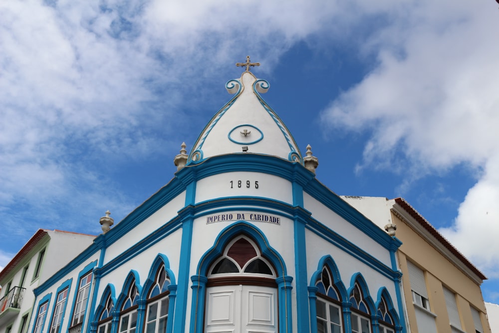 Weiß-blaues Betongebäude unter blauem Himmel tagsüber