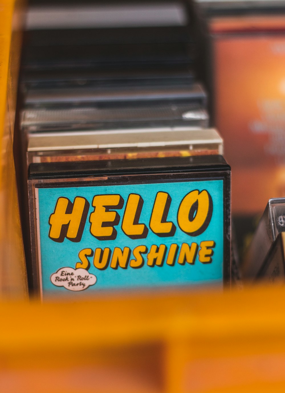 a close up of a hello sunshine sign on a shelf