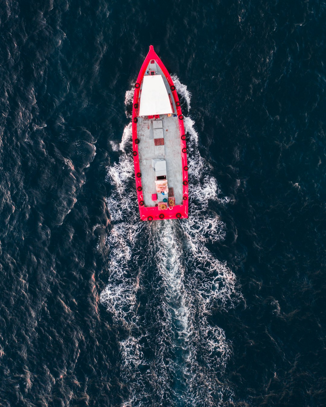 red and white boat on water during daytime