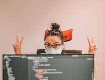 man in black framed eyeglasses doing peace sign