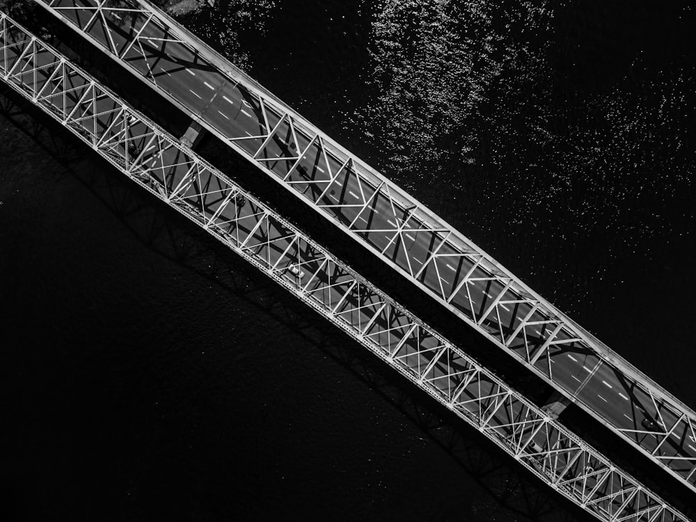 grayscale photo of metal bridge