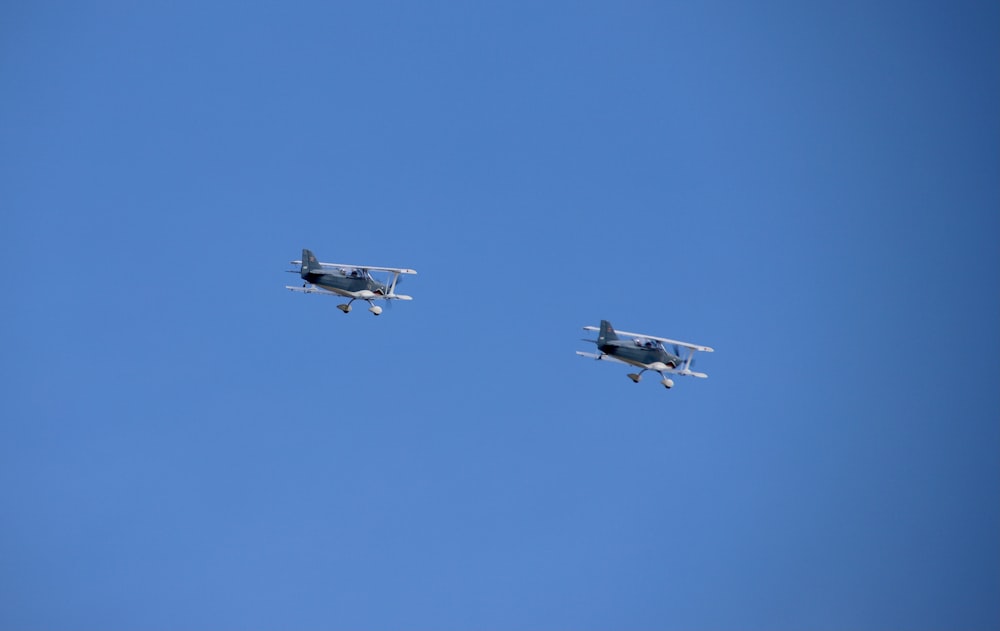 white jet plane in mid air during daytime