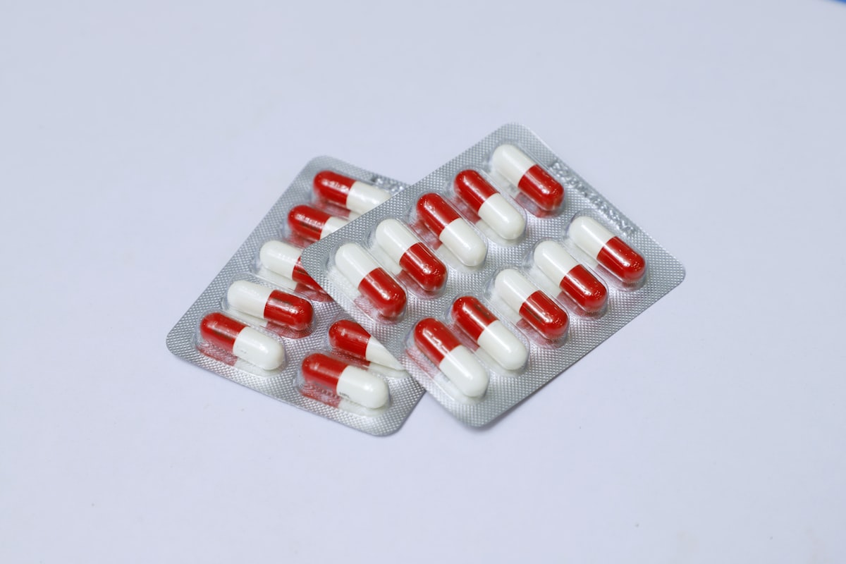 Red and white medication pill blister packs representing healthcare costs