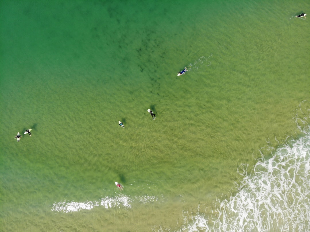 birds eye view of people surfing on sea waves