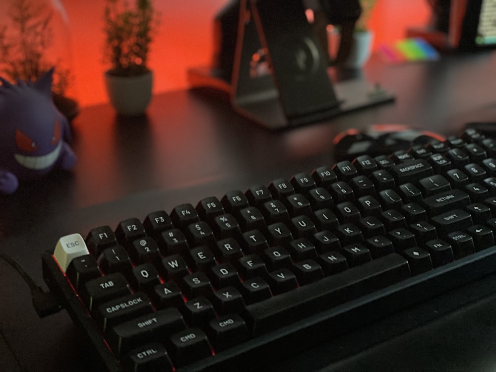 black computer keyboard on brown wooden table