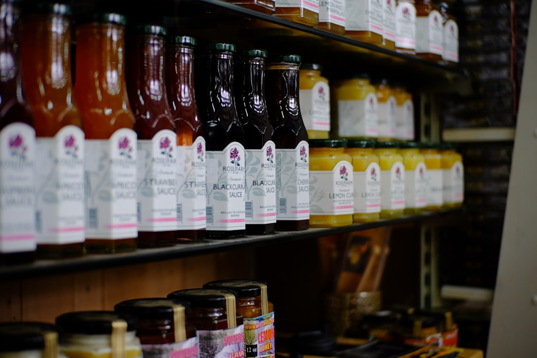 assorted bottles on brown wooden shelf