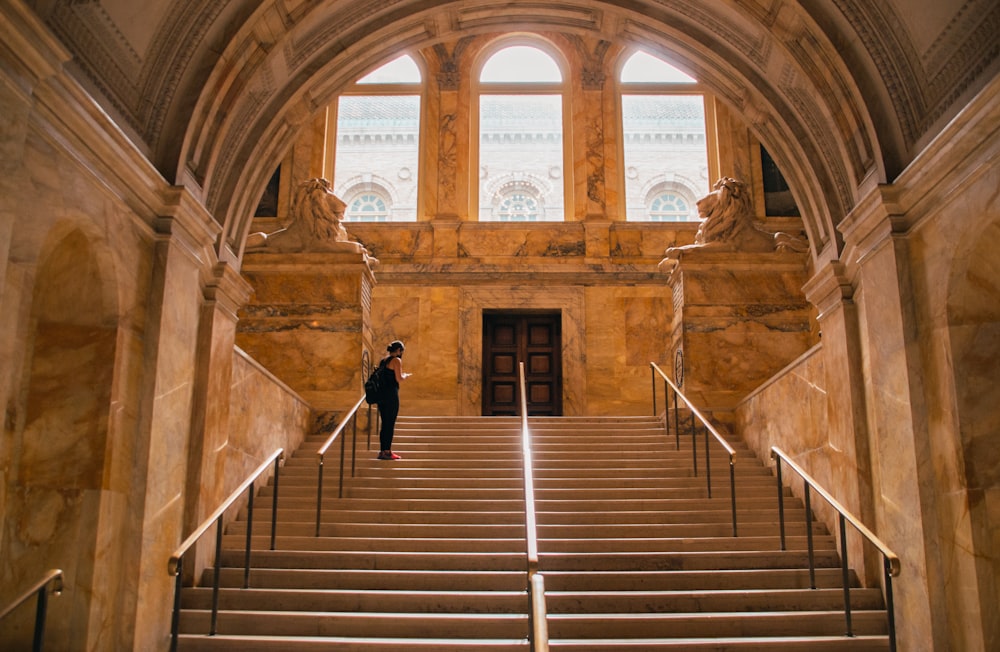 woman in black jacket walking on stairs