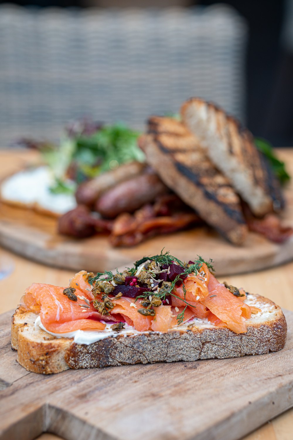 sliced bread with meat and vegetable on brown wooden table