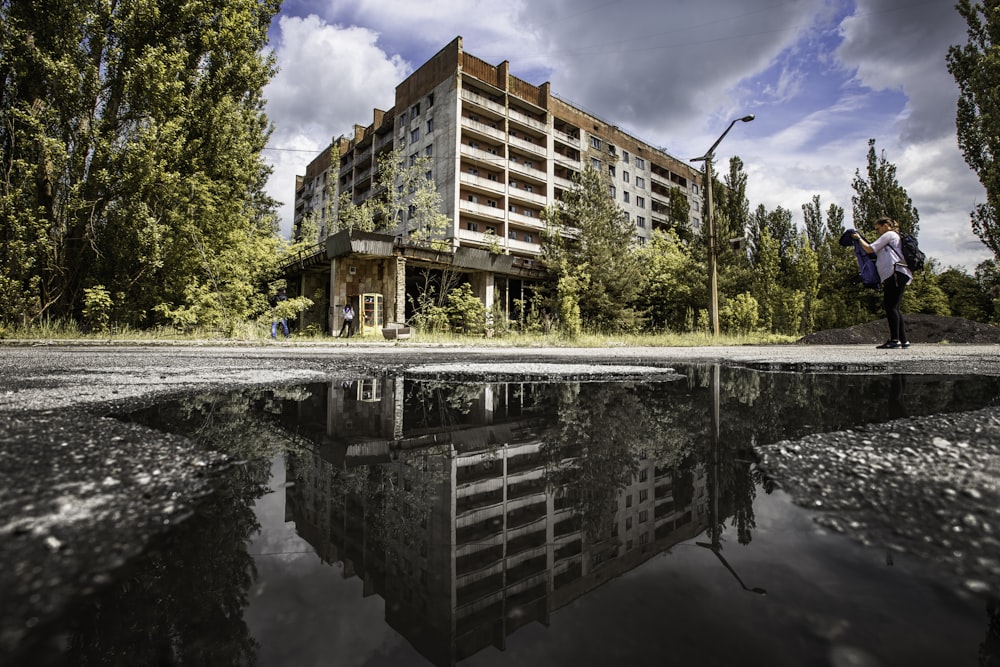 brown and white concrete building near green trees under blue sky during daytime