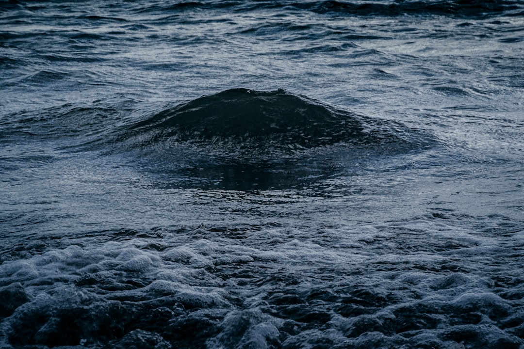 ocean waves crashing on shore during daytime