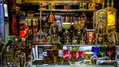 Close-up of colorful sweets and beverages displayed invitingly on wooden shelves.