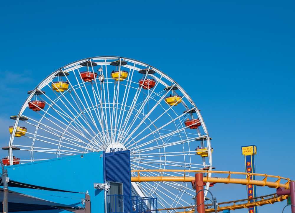 white ferris wheel under blue sky during daytime