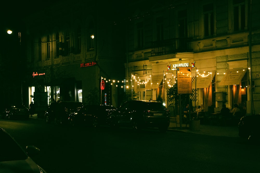 cars parked in front of building during night time