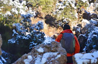 Outdoor enthusiast wearing the exoskeleton on a rugged hiking trail, showcasing durability.