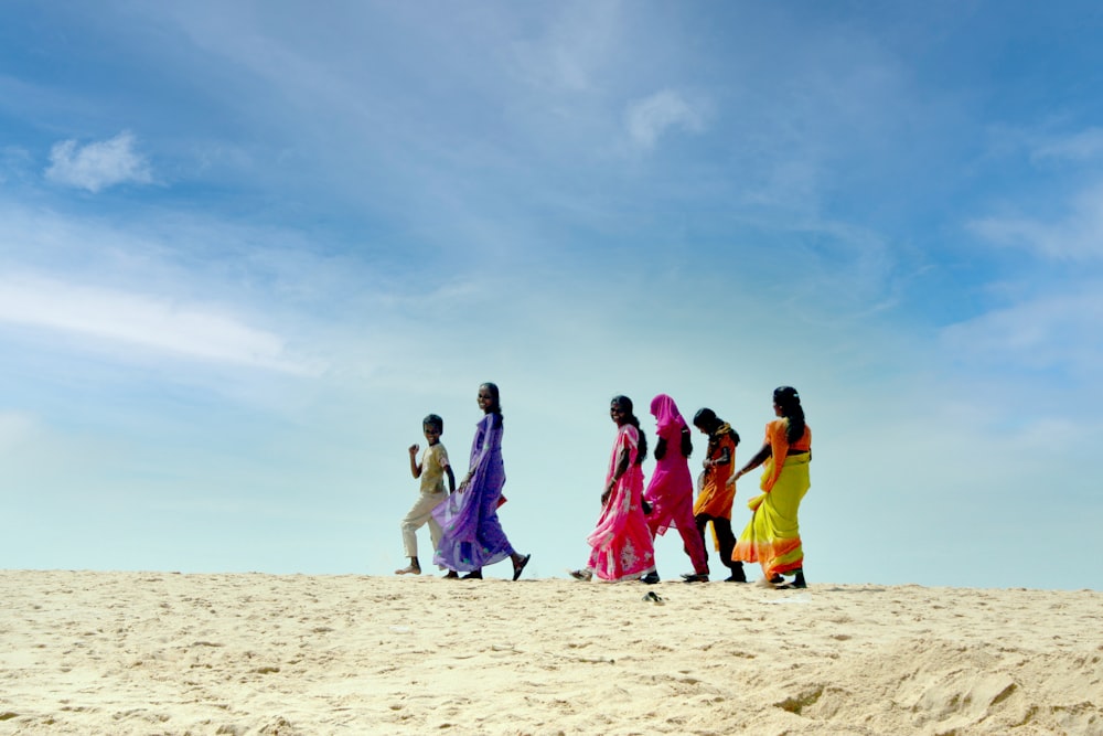 group of people walking on sand during daytime