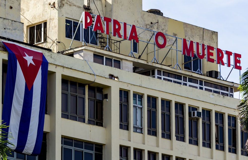 white concrete building with red and white signage