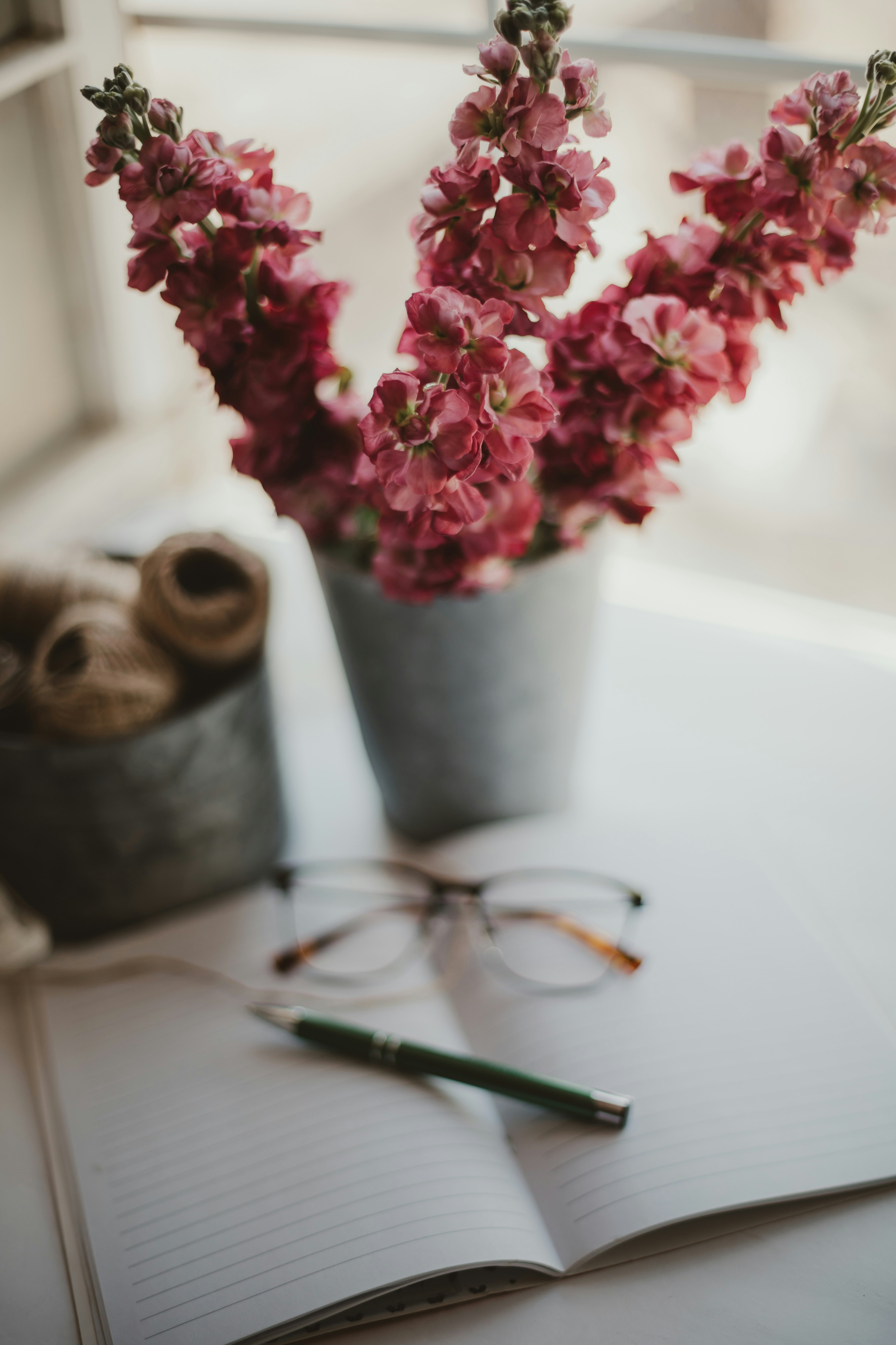 pink flowers in gray ceramic vase