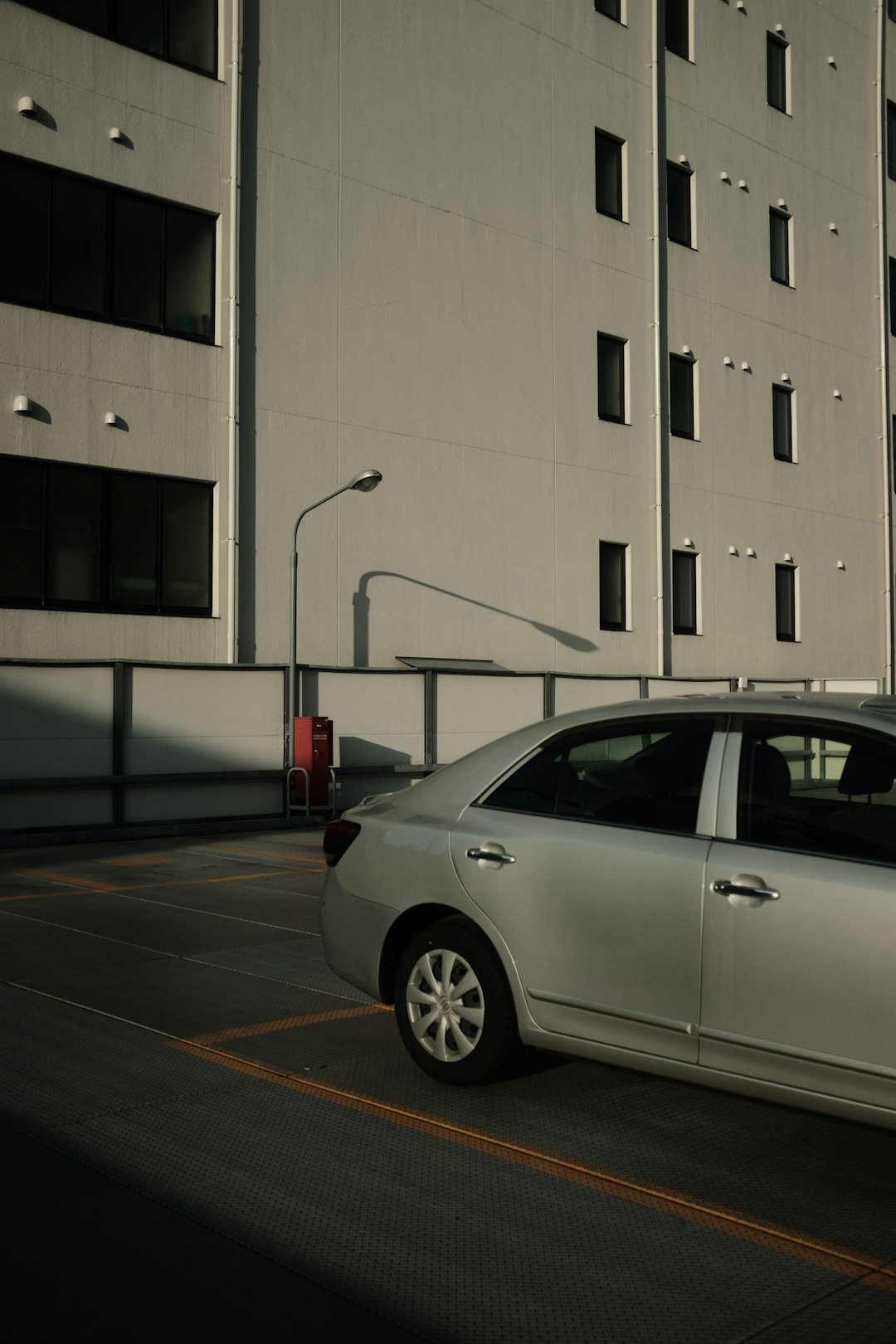 silver sedan parked on parking lot