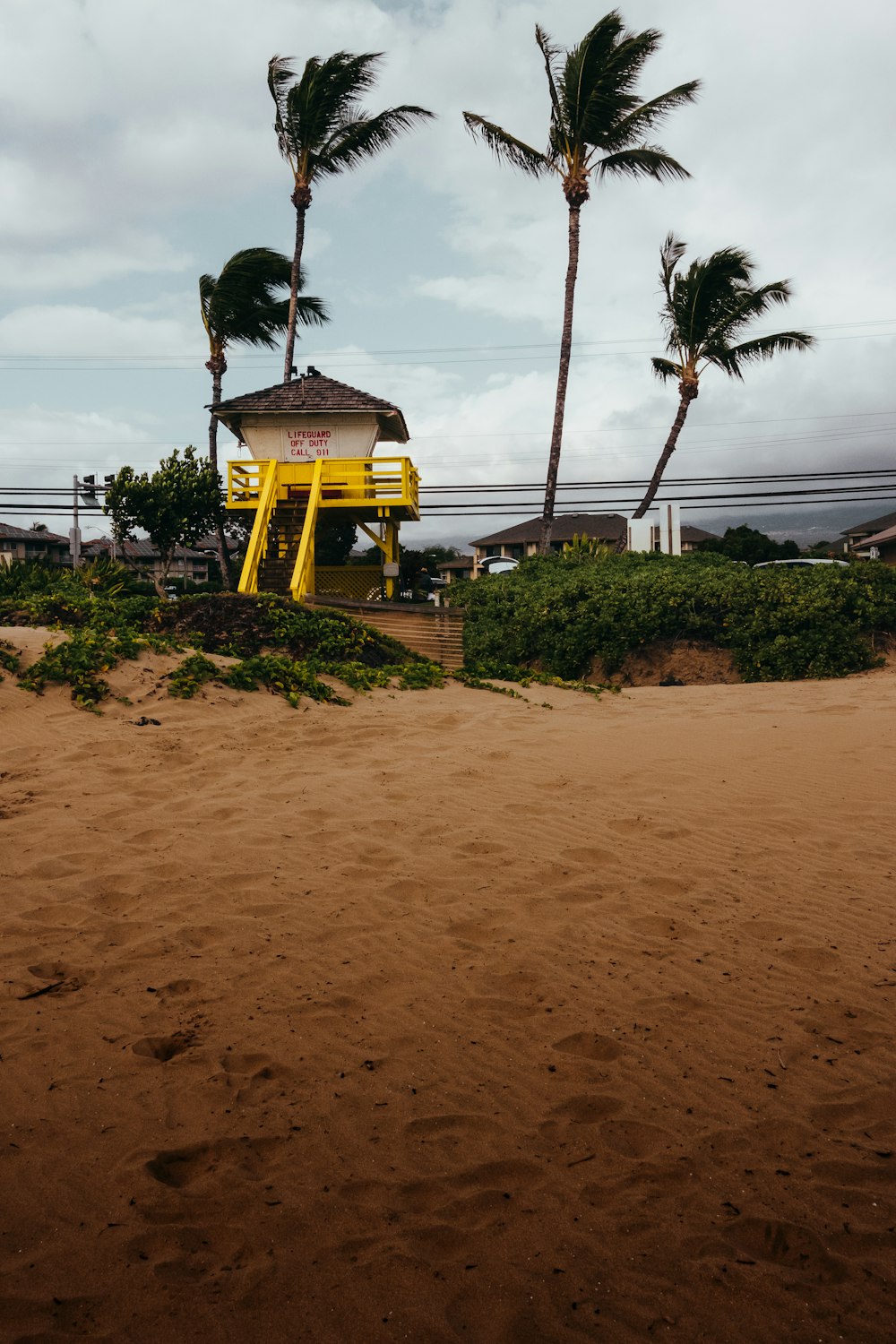 yellow and black swing near beach during daytime