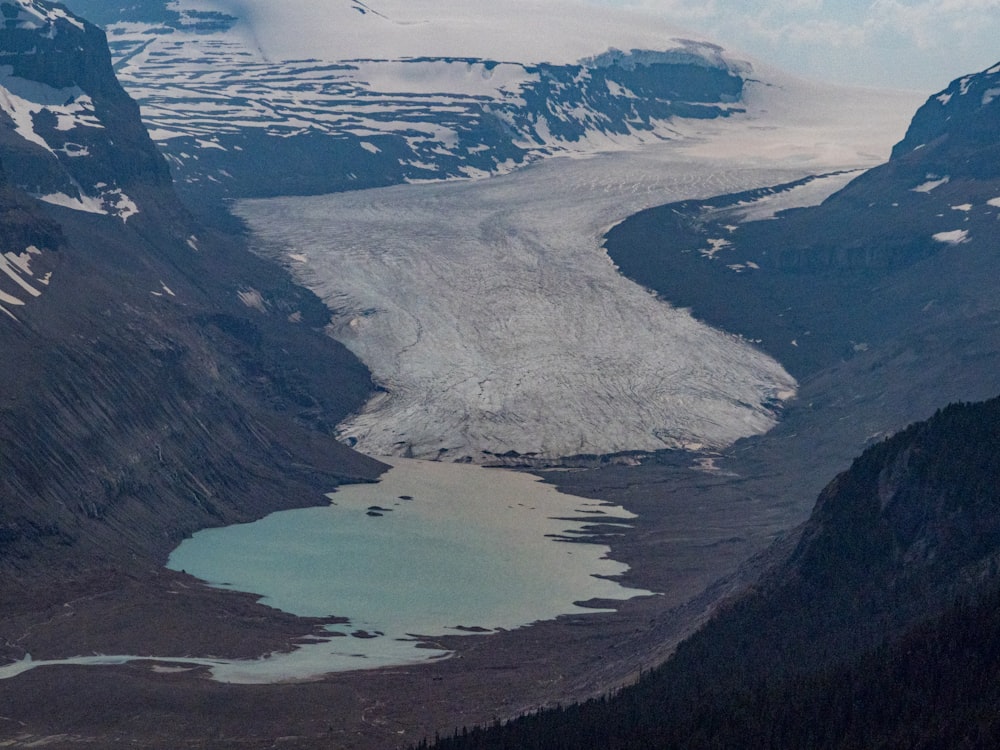 aerial view of lake between mountains during daytime