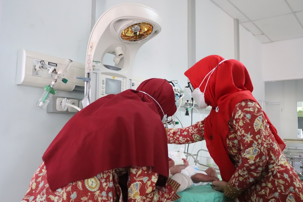 woman in red hijab sitting on bed