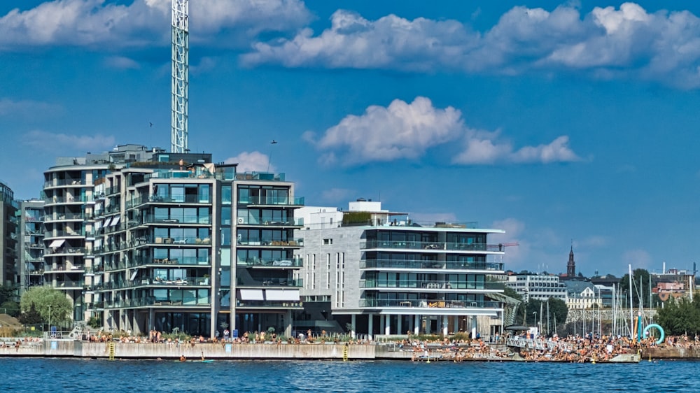 white and blue concrete building near body of water during daytime