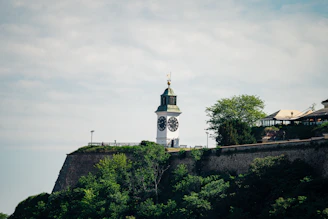 white and brown concrete building on top of hill