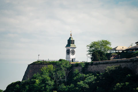 white and brown concrete building on top of hill