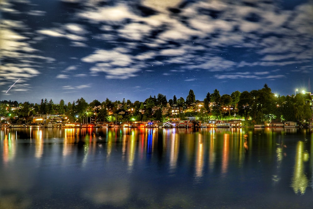 city lights on body of water during night time