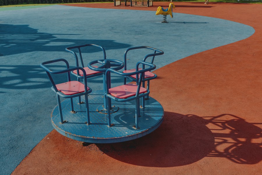 Beige PlayTiles around a childcare play structure