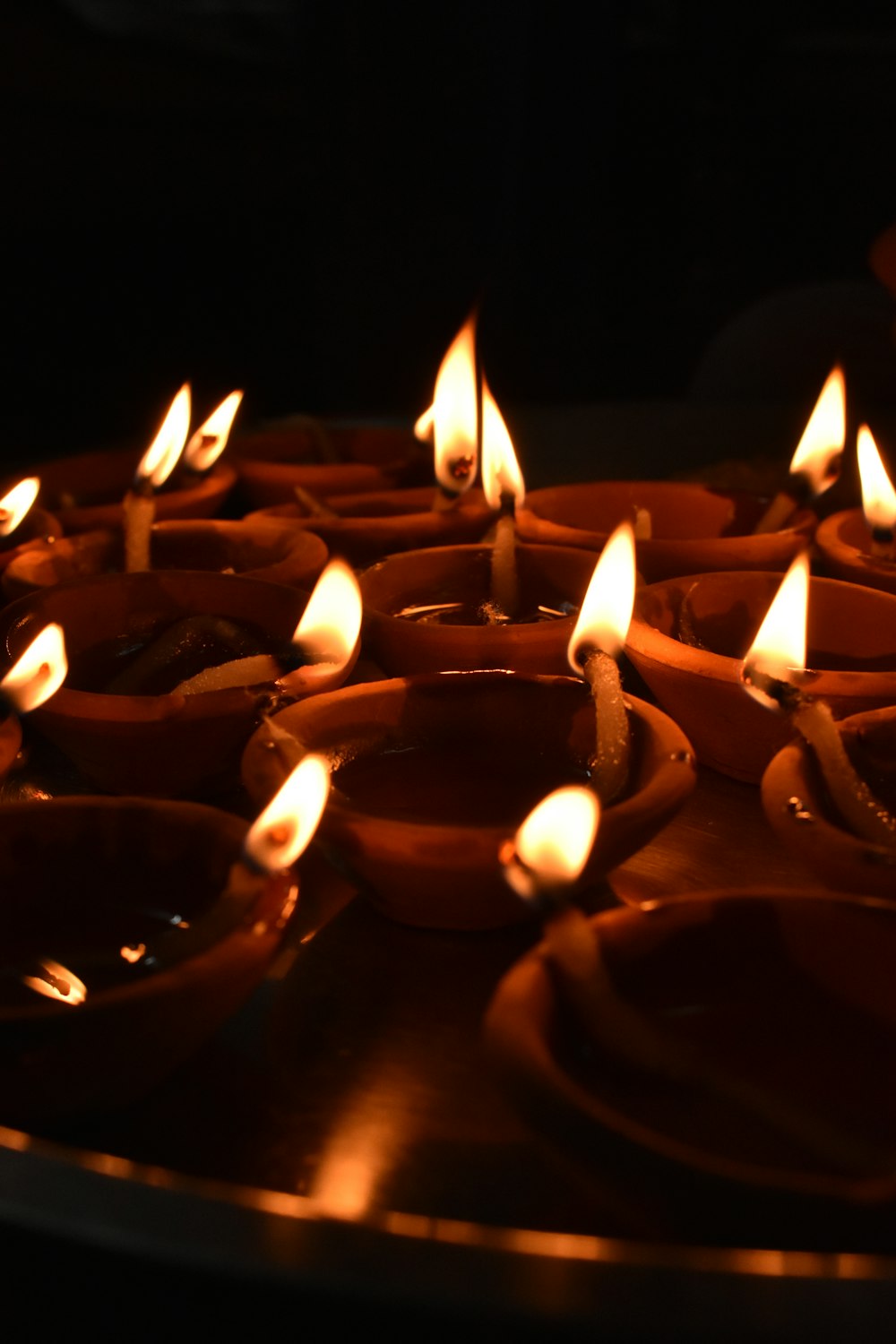 lighted candles on black surface