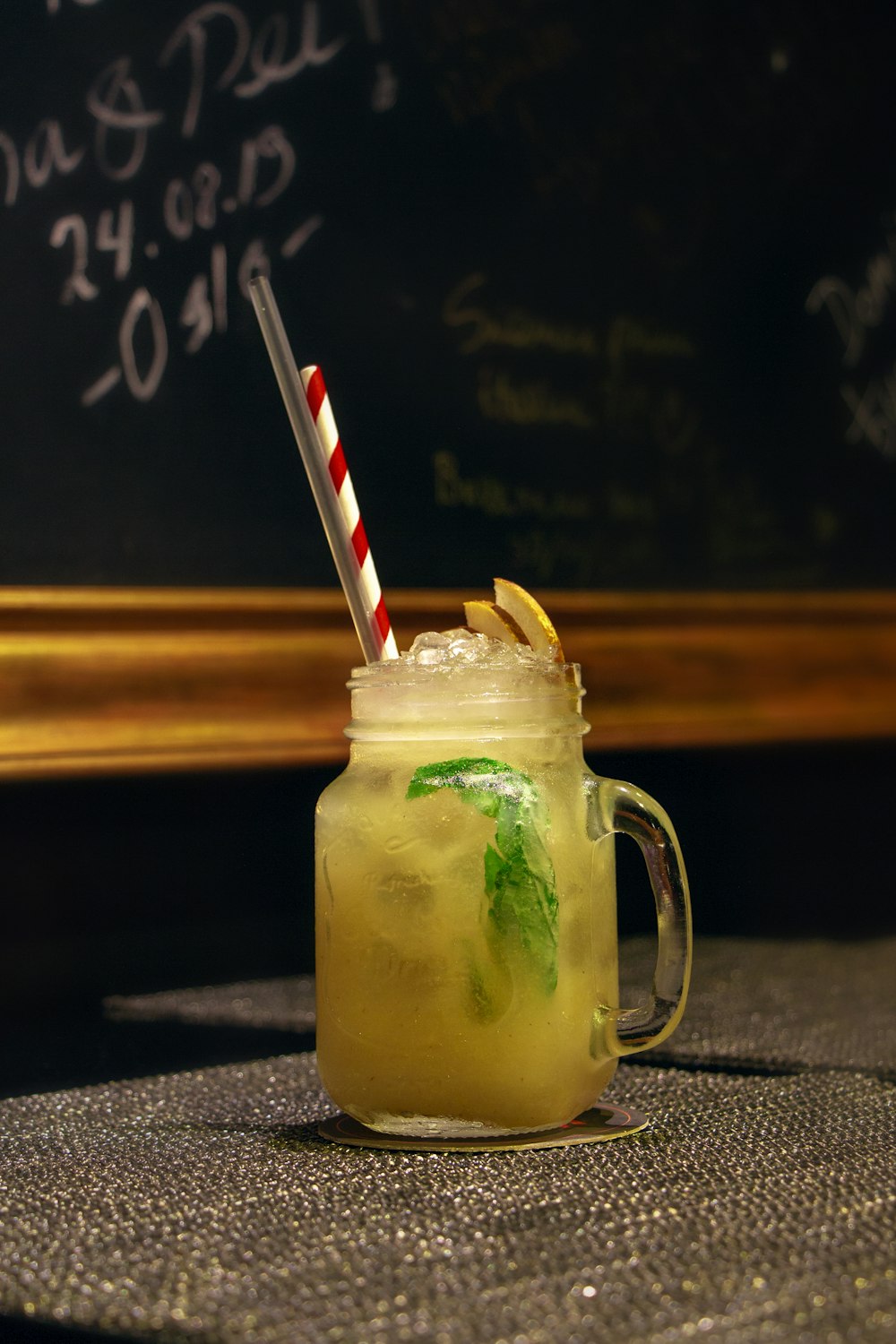 clear glass mug with red straw