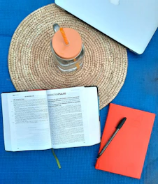 A flat lay of an open architectural course on a tablet alongside a printed CV template and design book.