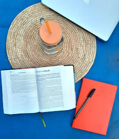 A flat lay of the blueprint ebook cover with gold and purple accents on a clean desk.