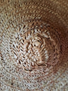 A close-up of a sun hat with intricate weaving patterns.