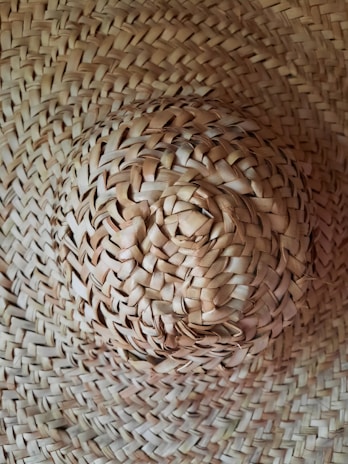 A close-up of a sun hat with intricate weaving patterns.