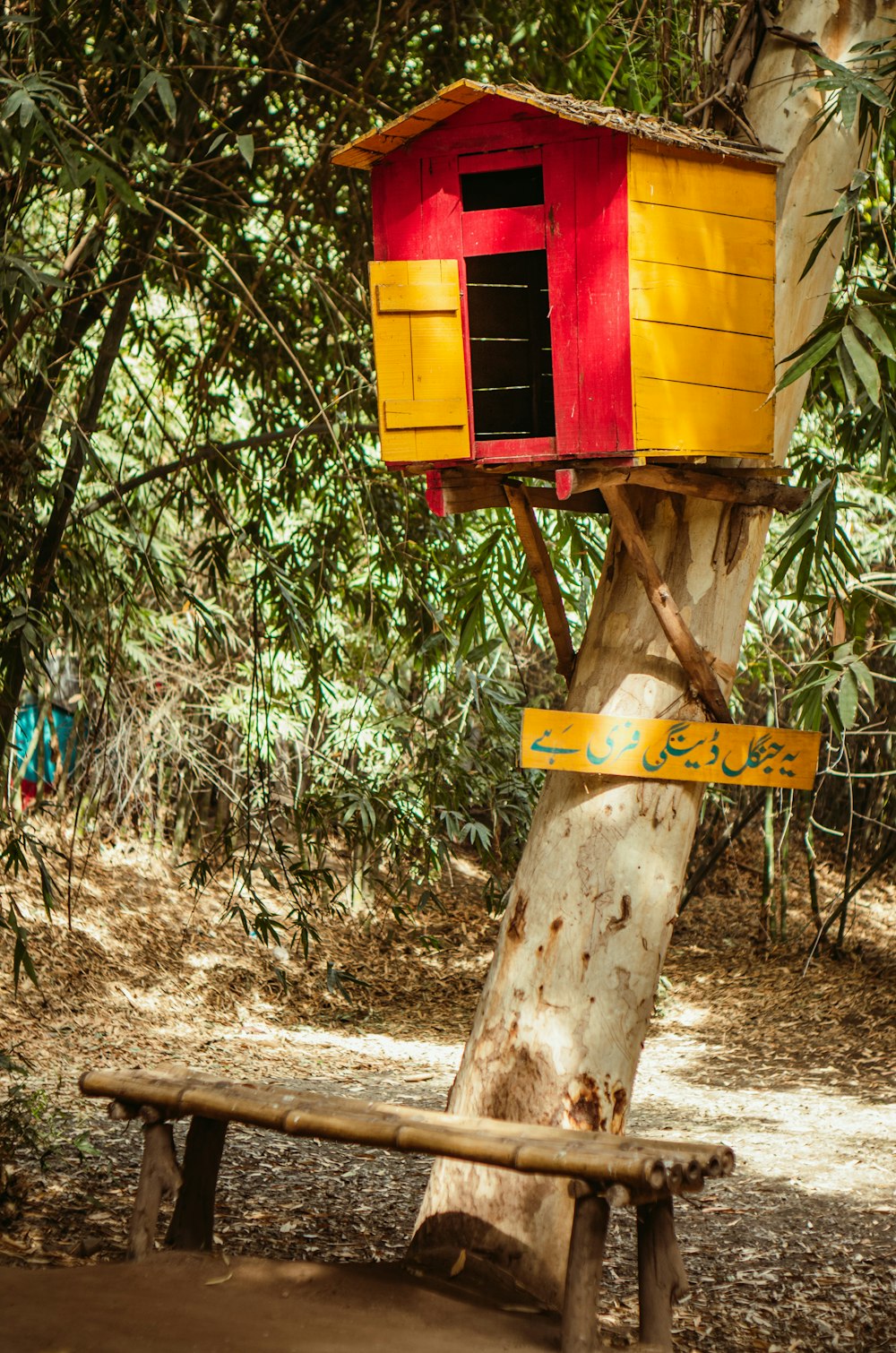 yellow and red wooden birdhouse