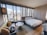 A cozy hotel room with modern decor and a view of Berlin's skyline.